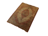Rare Haji Jalili silk Tabriz rug from an angle, showing its rust medallion and time-softened patina.