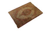 Angled perspective of the entire antique silk Tabriz rug, displaying its intricate medallion and aged patina.