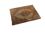 The complete design of a diminutive antique silk Tabriz rug, angled to show its rich, time-softened patina.