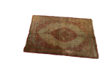 Angled view of a late 19th-century Haji Jalili silk Tabriz, showing its full medallion design.