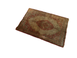 Angled perspective of a rare antique silk Tabriz rug with a rust-toned medallion on an ivory field.
