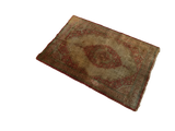 Oblique view of an antique silk Tabriz rug, showing the complete medallion design and layout.