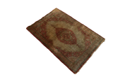 Angled view of an antique Haji Jalili Tabriz silk rug with a rust medallion on an ivory field.