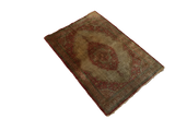 Antique silk Tabriz mat shown in full from a diagonal angle, displaying its rust medallion and border.