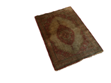 Angled view of an antique Haji Jalili Tabriz silk rug, highlighting its lustrous, time-softened ivory field.