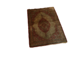 Angled full view of an antique silk Haji Jalili Tabriz rug showing its medallion and complex borders.