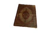 Angled view of an antique silk Persian Tabriz mat with its rust medallion and ivory field.