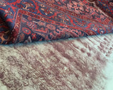 Professional cleaning in progress for a hand-knotted rug, showing the removal of deep dirt and stains.