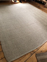 Modern natural beige chevron weave with a tightly bound edge.