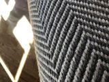Woven gray and off-white chevron pattern detail of the modern Dawn rug.