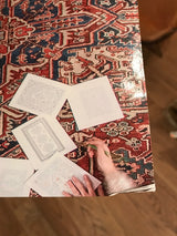 Corner of the rug coloring book cover showing an illustration of coloring pages.