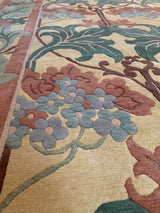William Morris design rug detail: raspberry, ocean green, blue blossoms on beige field.