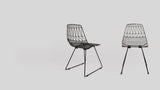 Black wire Lucy side chairs, modern geometric design shown from two angles.