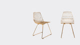 Modern Lucy copper wire chairs, showing angled and rear views.