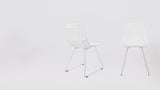 Two white wireframe Modern Lucy Side Chairs, angled views.