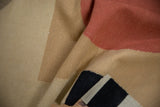Detail of hand-woven Kilim runner with textured madder root red, sand, and black shapes.