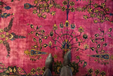 Painted floral details and haloed magenta color on a vintage hand-knotted Meshed carpet.