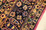 Golden floral border and cochineal red side cord on a vintage hand knotted carpet corner.