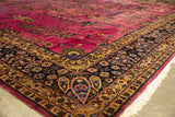 Richly detailed corner of a vintage Meshed carpet with a navy blue and gold floral border.
