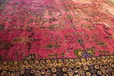 Potted plants and cypress tree motifs on the cochineal red field of a vintage Meshed carpet.