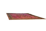 Angled view of the vintage Meshed carpet, emphasizing its large scale and magenta-red field.
