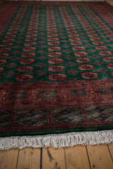 Vintage Bokhara carpet's fine emerald green, rust, navy geometric end border with ivory fringe.