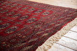 Detailed side cord selvage next to the cherry red pile on a vintage Bokhara runner.