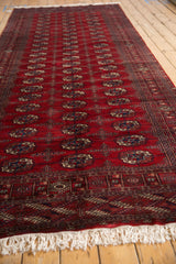 Angled view of the Bokhara runner showing its repeating gul pattern and white fringe.