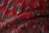 Plush, lustrous wool pile and fine weave of a vintage cherry red Bokhara rug.