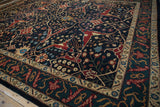 A close view of the vintage carpet's dragon-inspired border in mallard green, red, and gold.