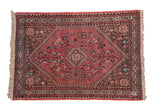 Vintage hand-knotted Persian Abadeh rug with dusty blush field, diamond medallion, and nature motifs.