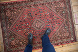 Vintage Abadeh rug showing dusty blush and coffee brown field with intricate motifs underfoot.