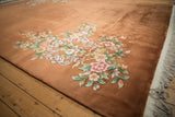 Shallow carved, embossed border design of the Art Deco rug in tone-on-tone copper.