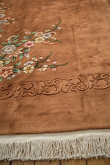 Dimensional piled carving creates a tone-on-tone border of the Art Deco carpet with fringe.