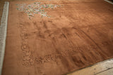 Shallow carved, embossed border design on the copper-hued vintage Art Deco carpet.