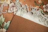 Vintage Chinese Art Deco rug corner with embossed copper floral pile, fringe, and woven back.