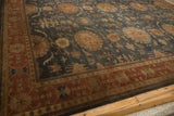 Terracotta border with geometric motifs beside a dusty blue field of palmettes and vinery.