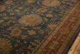 Detailed view of traditional terracotta palmettes and vinery on a dusty blue Indian Bijar rug.