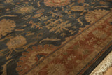 Vintage Indian Bijar rug's terracotta border with floral arabesques and cream fringe.