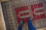 Double niche prayer design in cherry red and charcoal on a fine vintage Pakistani rug.