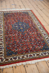 Side angle view of the vintage Ardebil rug, showing the dense pile and intricate Herati design.