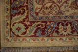 Corner of a vintage Indian carpet showing the detailed palmette border and original full pile.