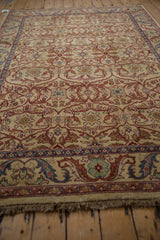 Perspective view of the vintage Bijar design carpet's full pile and floral lattice pattern.