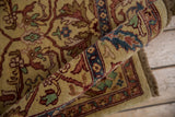 Rolled corner of a vintage Indian carpet showing its high luster wool and dense, full pile.