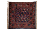Vintage Bokhara square rug with a traditional gul pattern in navy blue, chestnut rust, and ivory.