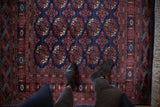 Overhead view of the plush wool pile and repeating gul medallions on a Bokhara rug.