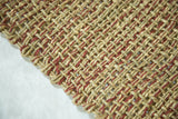Diagonal weave of handmade seagrass and jute rug with reddish-brown strands.