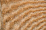 Tight, ribbed texture of the natural jute woven Cali carpet in beige.