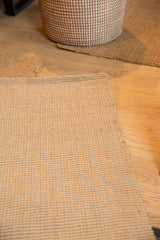 Detailed view of the Cali jute carpet's tight natural weave and finished edge.