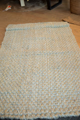 Chunky woven texture of Elsa Jute rug, showing blue, gray, and natural fibers.